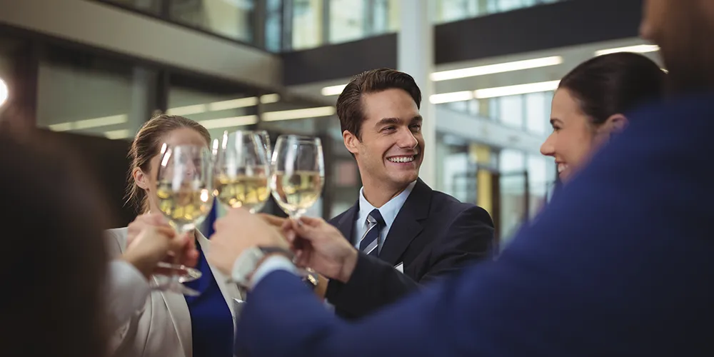 businesspeople toasting glasses of champagne in a corporate event